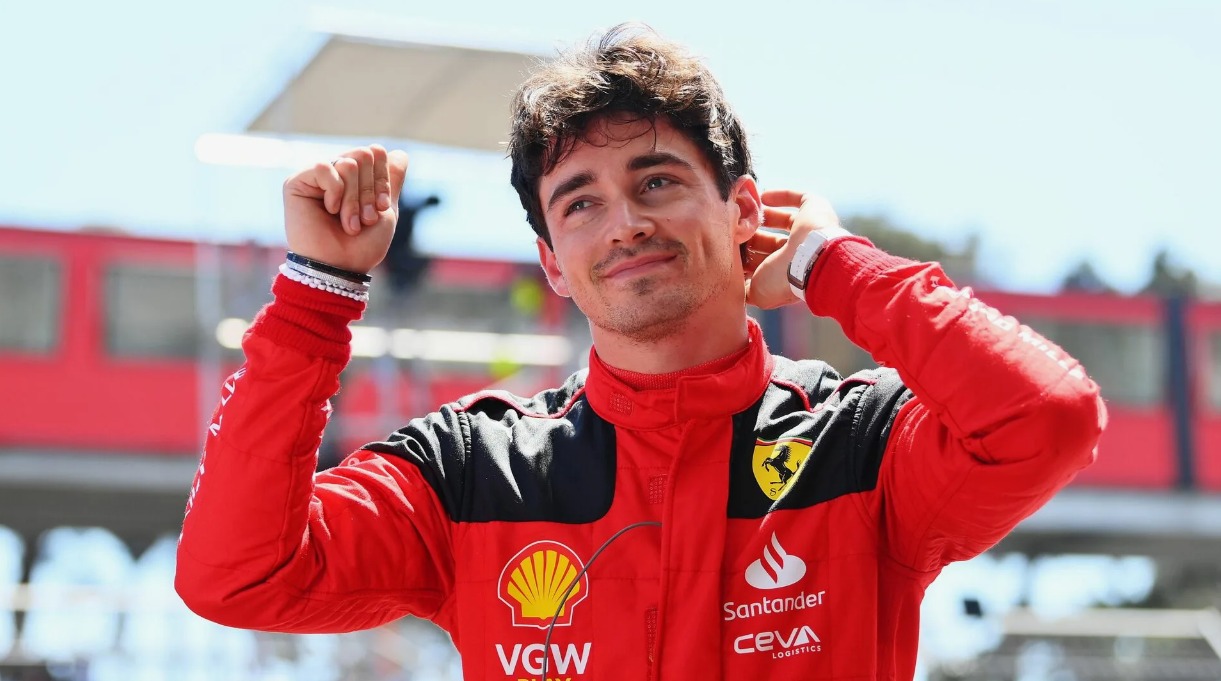 Charles Leclerc driving a Ferrari car at high speed on a race circuit