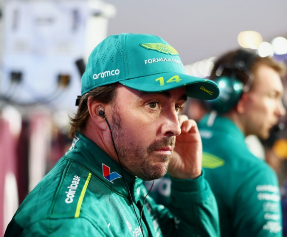 Fernando Alonso talking with engineers in the team garage