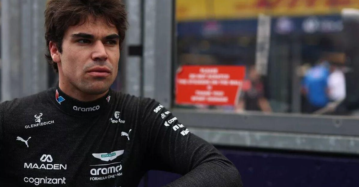 Lance Stroll collaborating with engineers and team members during a Formula 1 race weekend