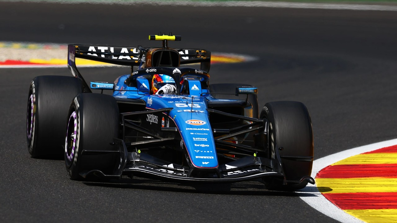 A blue Williams Formula 1 car drives on the circuit