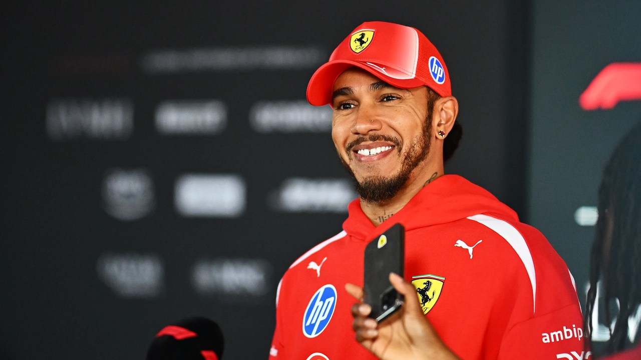 Lewis Hamilton speaks to reporters in Ferrari clothing at the Hungaroring