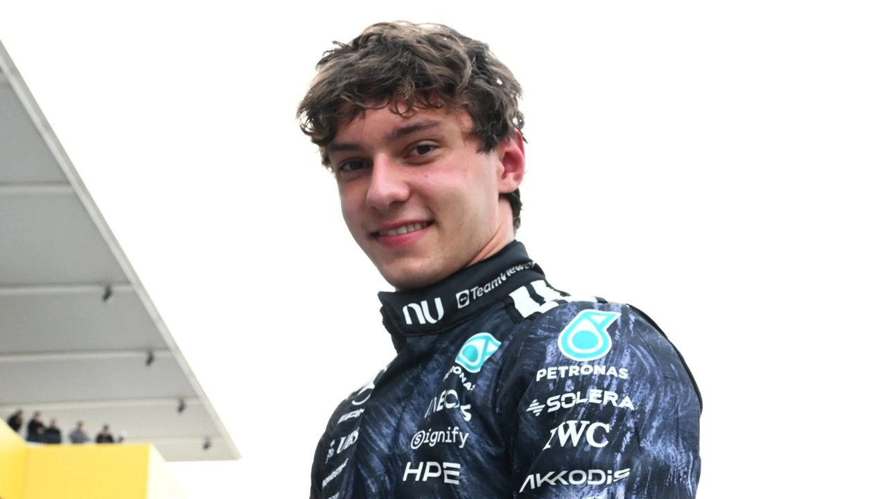 Kimi Antonelli smiles in his Mercedes race suit