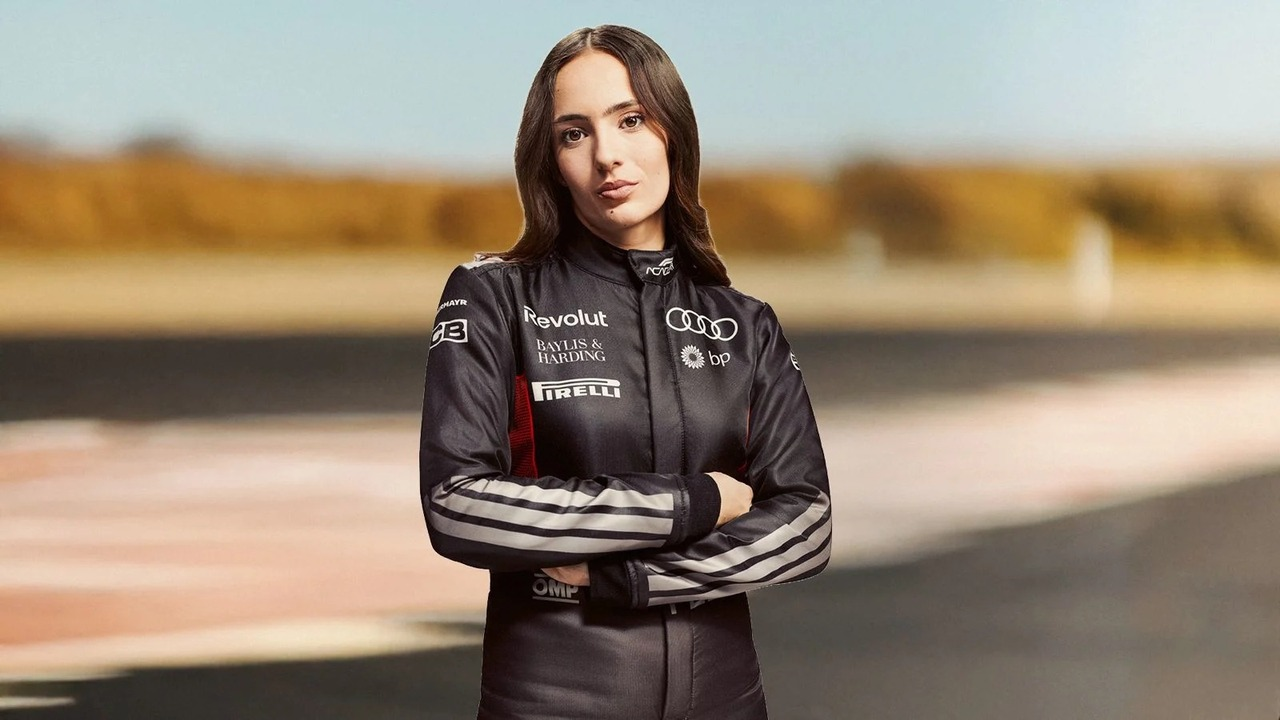 Emma Felbermayr stands in an Audi F1 Academy race suit