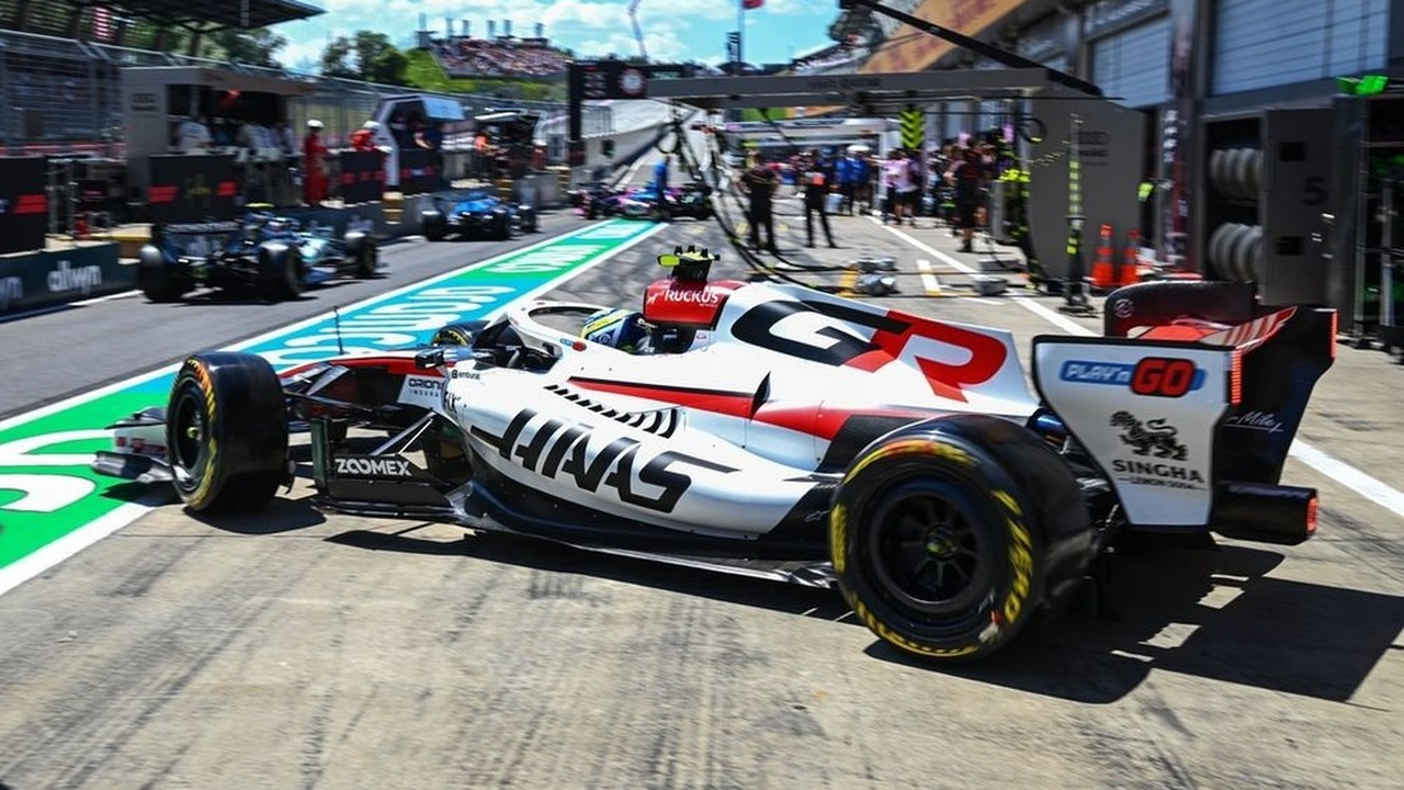 A Haas Formula 1 car stands in the pit lane