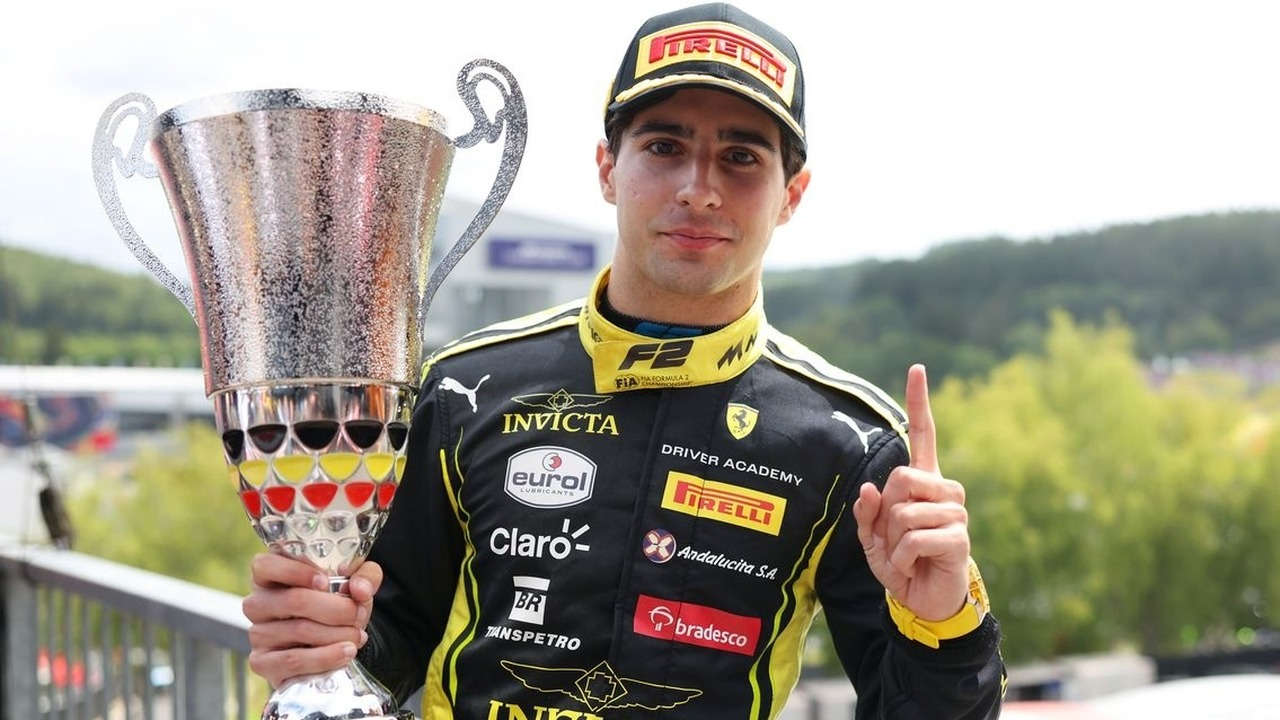 Rafael Camara solleva un trofeo indossando la sua tuta da corsa.